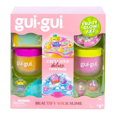 Gui Gui Deluxe Twin Pack Fruity Glow von vorn: rosa Schachtel mit Sichtfenstern, darin eine orange und eine pinke Slime-Dose, Mini-Figuren und Zubehör